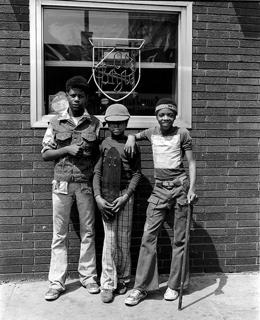 Three kids in front of bar